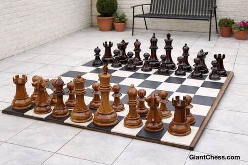 Giant teak chess set photo
