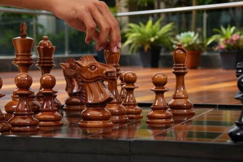 Giant teak chess set photo