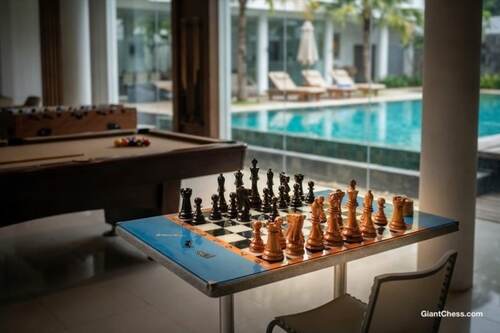 Giant teak chess set photo